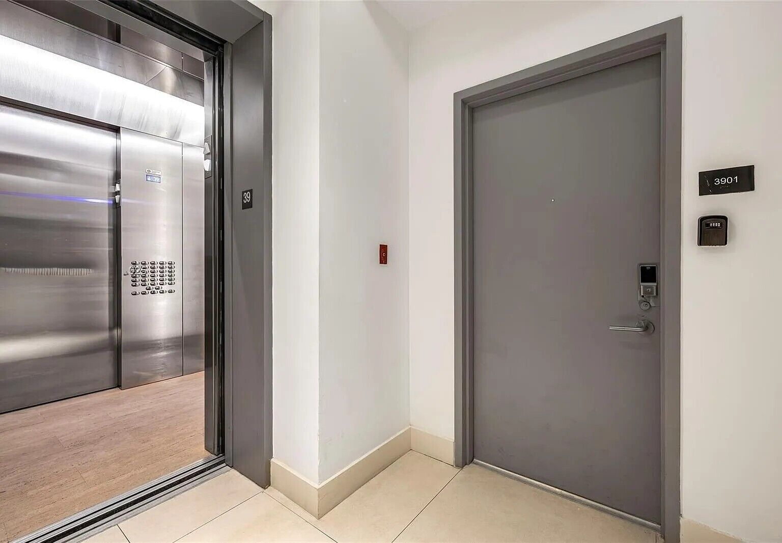 An elevator with a metallic finish and a door with a digital lock.