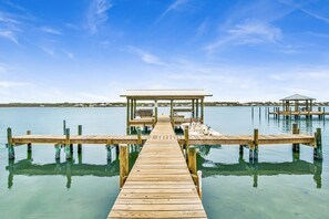 Guests can enjoy a serene waterfront experience from the covered seating area.