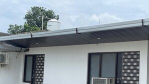 A modern building with two doors, one with a metal grille and the other with a patterned design. - Parinay Vatika Banquet & Party Lawn (Haldwani)