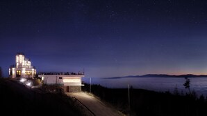 A modern building with a sign reading "Monte Mory" and a view of the sea at night. - APLEND Monte Móry (Štrba)