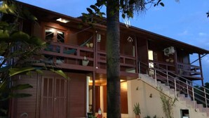 A two-story building with a staircase leading to the upper level. - Pousada Recanto do Neca (Florianópolis)