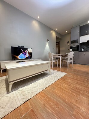 Luxury Apartment | Living area | Flat-screen TV