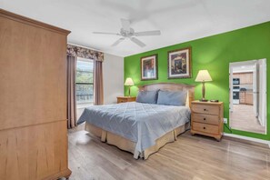 A bedroom with a bed, two bedside tables with lamps, a ceiling fan, and a wardrobe. - C-224 - End Unit with Private Views & Sleeps 6 (Naples)