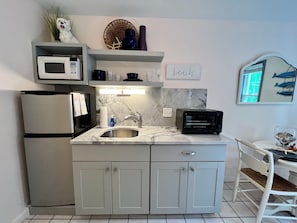 Fridge, microwave, cookware/dishes/utensils, dining tables