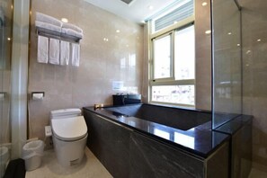 A modern bathroom with a black marble sink, a toilet, and a glass shower enclosure. - Muen Yuan Dong Hot Spring Hotel (Yilan)