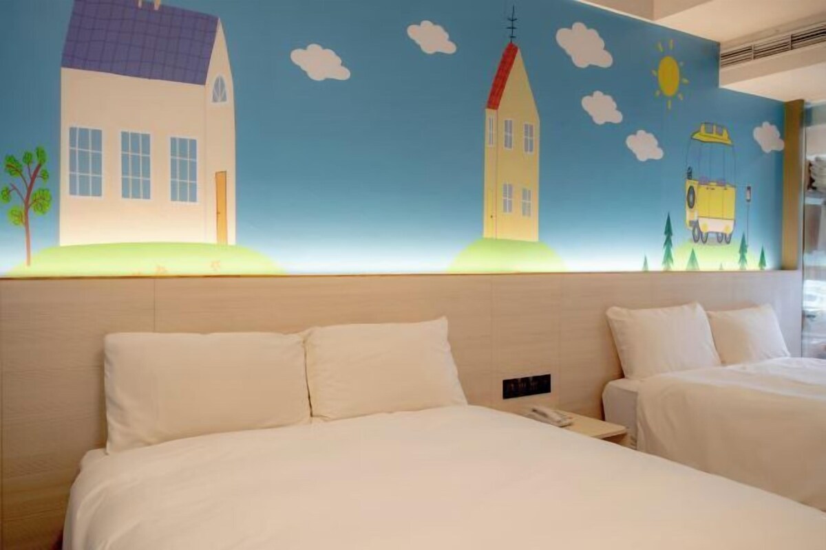 A hotel room with two beds, a large mural on the wall depicting houses and a yellow car, and a simple, clean design.