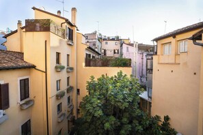 Stroll through a charming, historic neighborhood lined with traditional Mediterranean-style buildings and lush greenery.