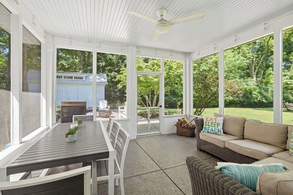 Dine, relax, and soak in the serenity—this porch is your year-round retreat.
