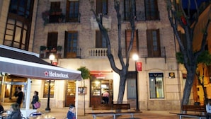Un edificio con un letrero de Heineken, un banco de 'La Caixa' y un letrero de 'Banca Pop'.