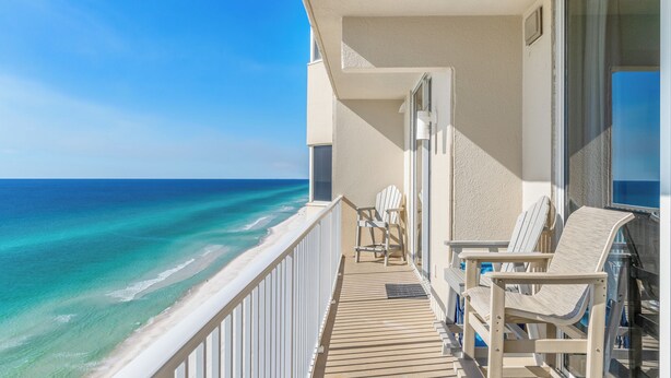 A balcony with a view of the ocean, wooden deck, and two Adirondack chairs. - *Oct 10 - 18th Getaway! * Beach Chairs! (Panama City Beach)