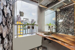 Enjoy a balcony with a sink, plants, and a view of the surrounding area.