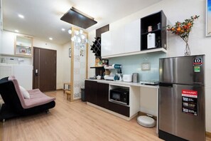 Enjoy a functional kitchen with a stainless steel refrigerator, microwave, and coffee maker, perfect for casual dining or relaxation.