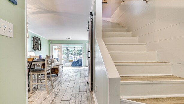 A staircase with white walls and wooden steps leading to an upper floor. - Chic Murrells Inlet Getaway ~ 2 Mi to Marsh Walk! (Murrells Inlet)