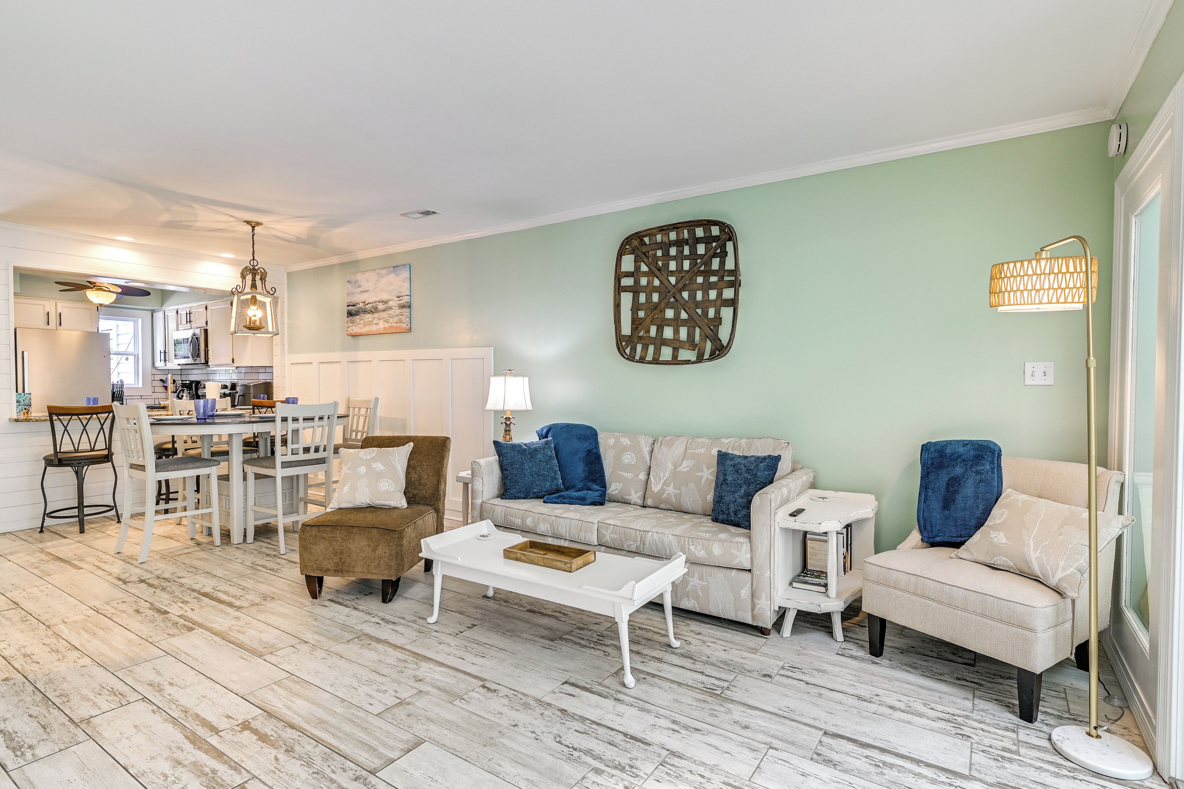 A spacious living room with a dining area, a sofa set, and a coffee table.