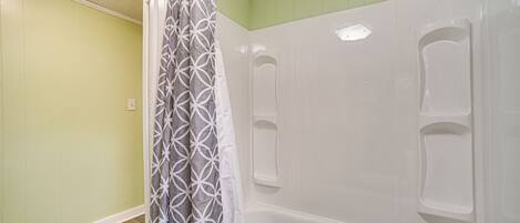 A bathroom with a bathtub, a shower, and a toilet.