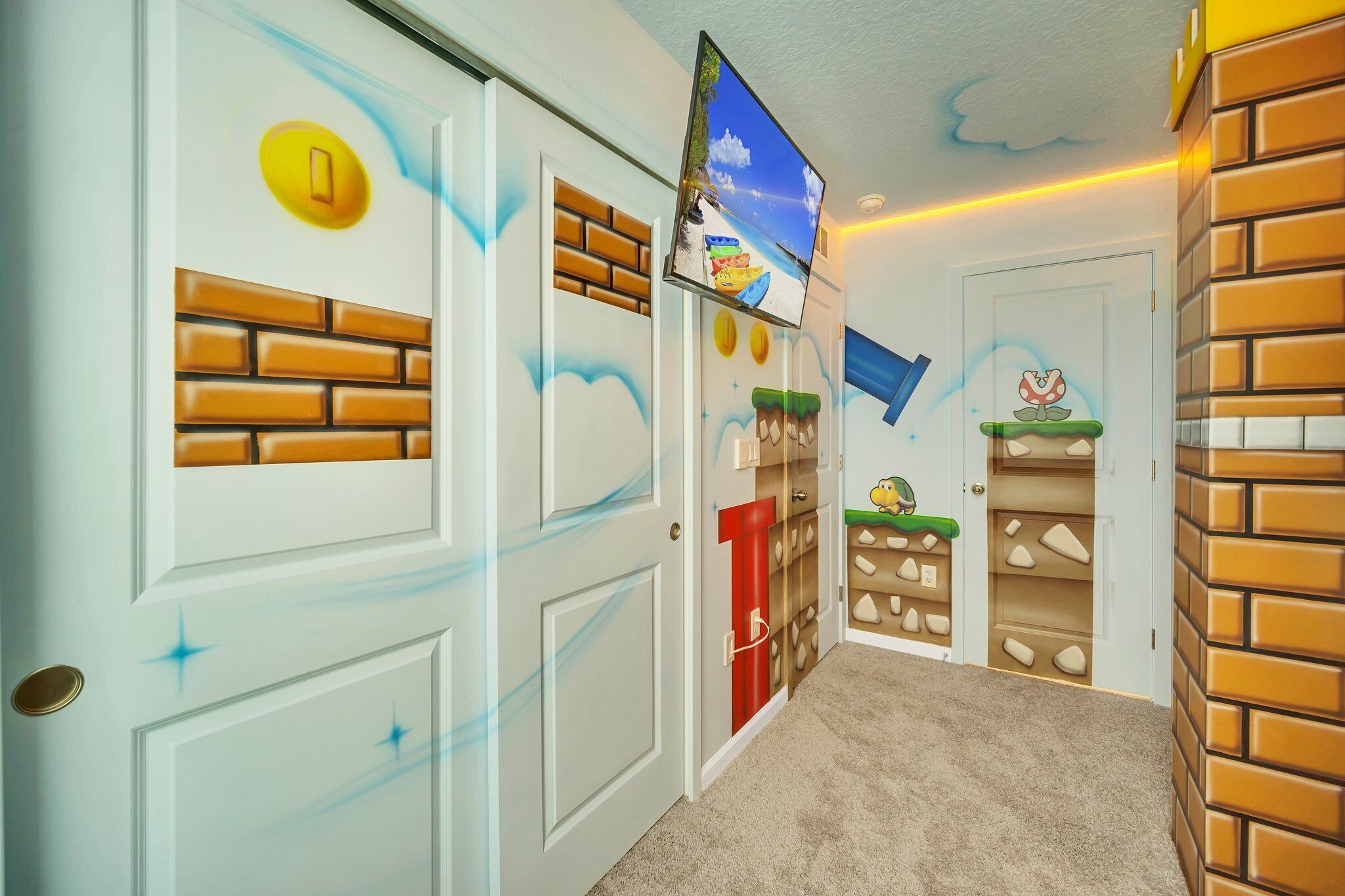 A hallway with a brick wall on the right, a door with a yellow handle on the left, and a television mounted on the wall.
