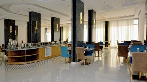 A modern hotel lobby with a marble reception desk, plush seating, and large windows. - AW Hotel Riyadh (Riyadh)