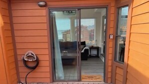 A wooden exterior with a sliding glass door leading to a living area. - Oceanview Cabin 22 w Jacuzzi Wonderful View (Smith River)