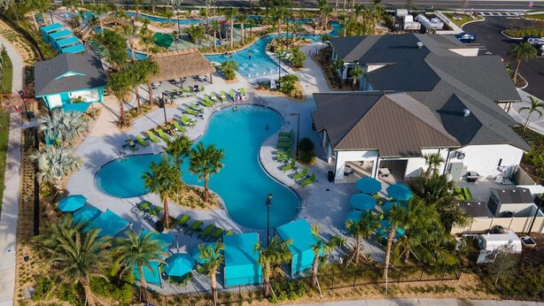 A resort with multiple swimming pools, lounge areas, and a covered pavilion. - SL 4Br Walking Distance to Club (Kissimmee)