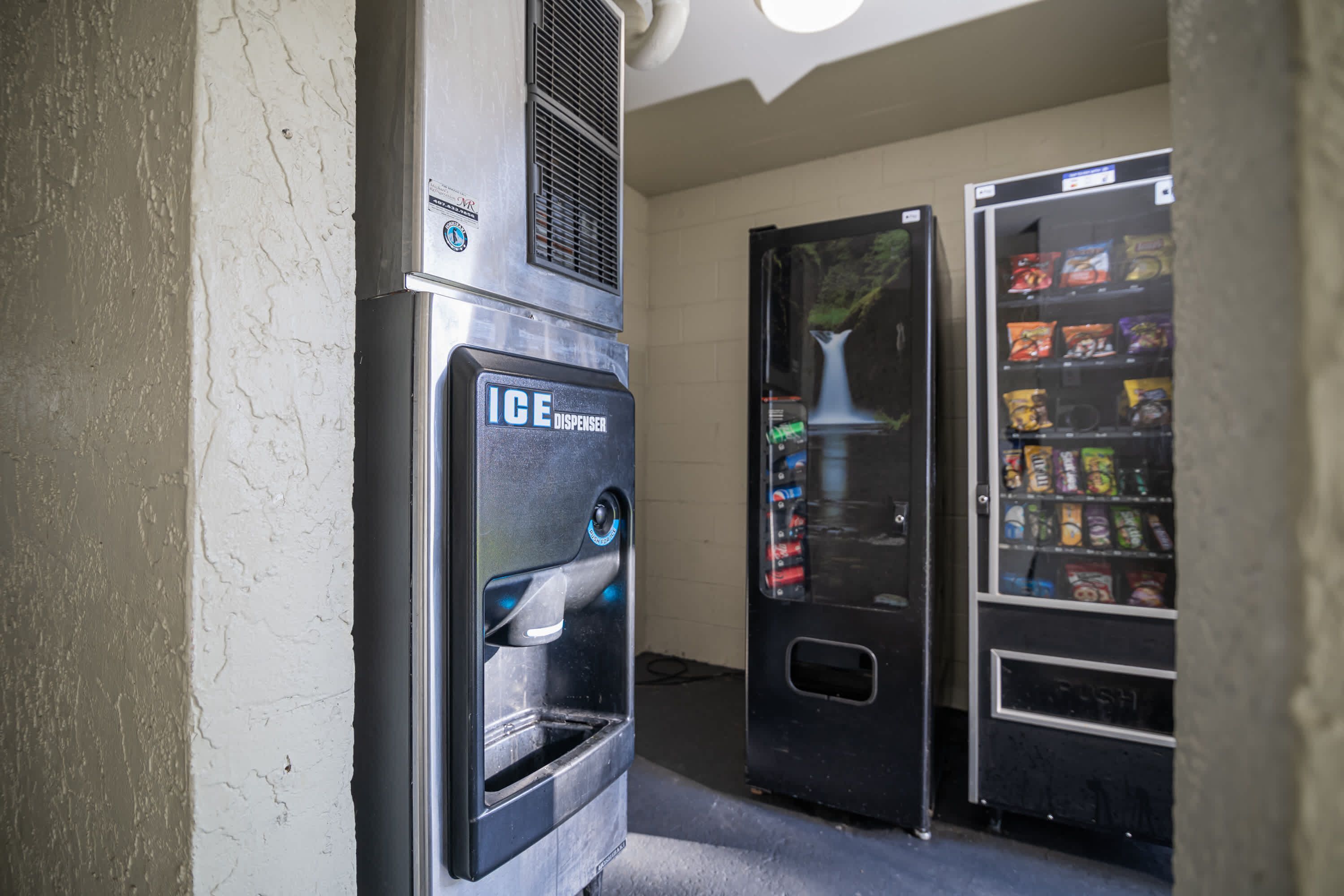 A vending machine with an ice dispenser and a selection of snacks.