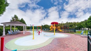 A playground with a covered seating area and a brick-paved surface. - Enchanted Townhome Near Disney Parks 3Br (Kissimmee)