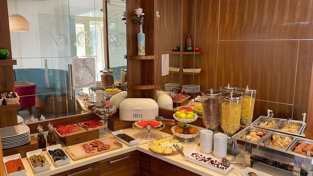 A buffet with various food items, including fruits, cereals, and pastries. - Hotel Atina by ENTOPYA (Budva)