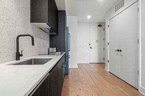 Condo, 1 King Bed with Sofa bed, Balcony, City View | Private kitchen | Full-size fridge, oven, stovetop, dishwasher - Modern Rainey St Oasis with Pool & Views (Austin)