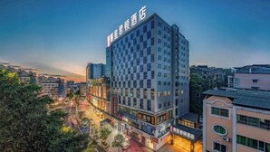A modern hotel with a checkered facade, multiple floors, and a prominent signage. - Rezen Kingtown Hotel (Chongqing Liangping) (Chongqing)