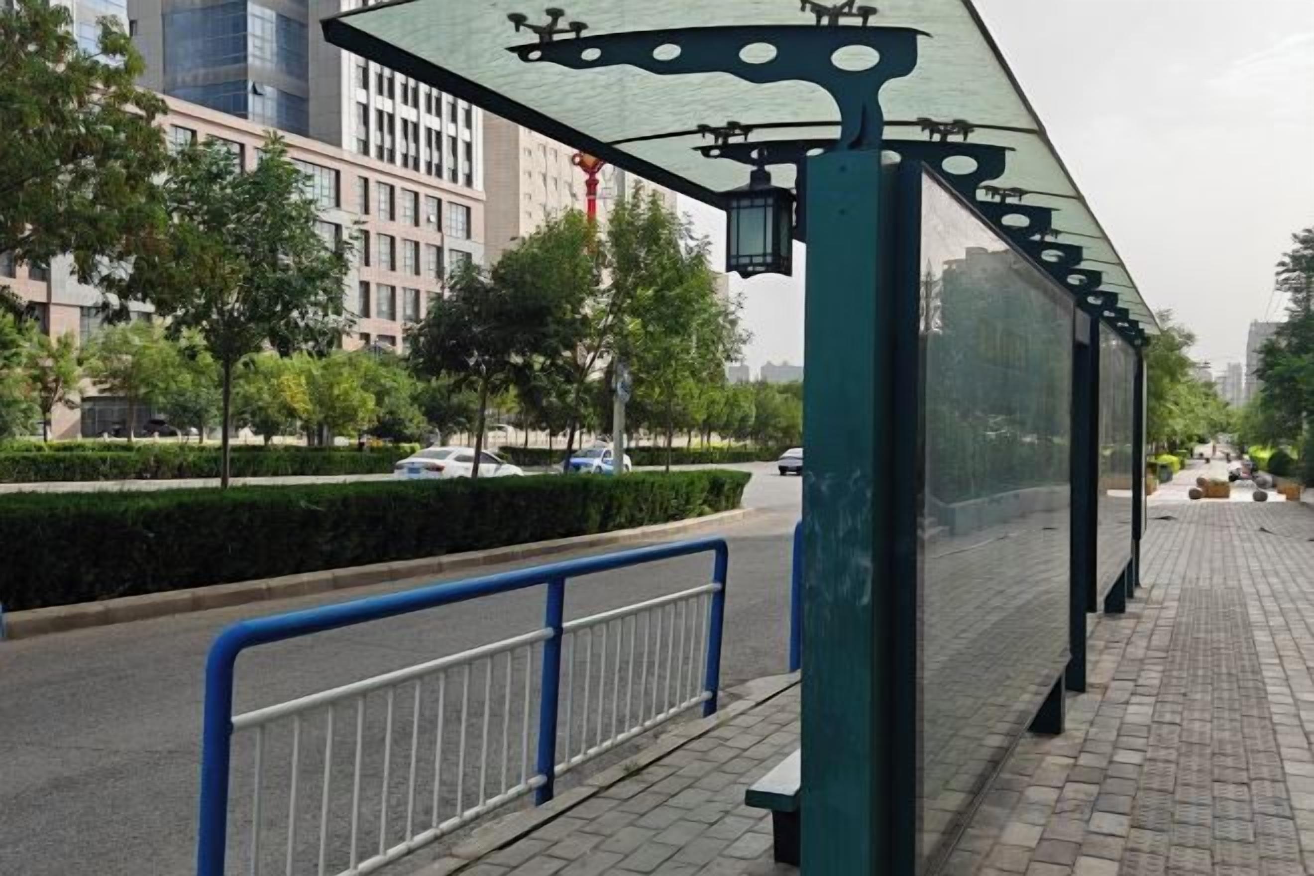 A covered pedestrian walkway with a metal railing, a street with cars, and buildings in the background.