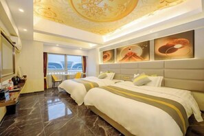 A hotel room with two beds, a large window, a ceiling with a floral design, and artwork on the wall. - Bandao Holiday Hotel (Changde)