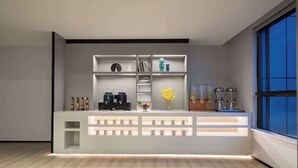 A modern reception desk with a minimalist design, featuring a light wood finish and integrated lighting. - Microtel By Wyndham Changsha South Railway Station (Changsha)