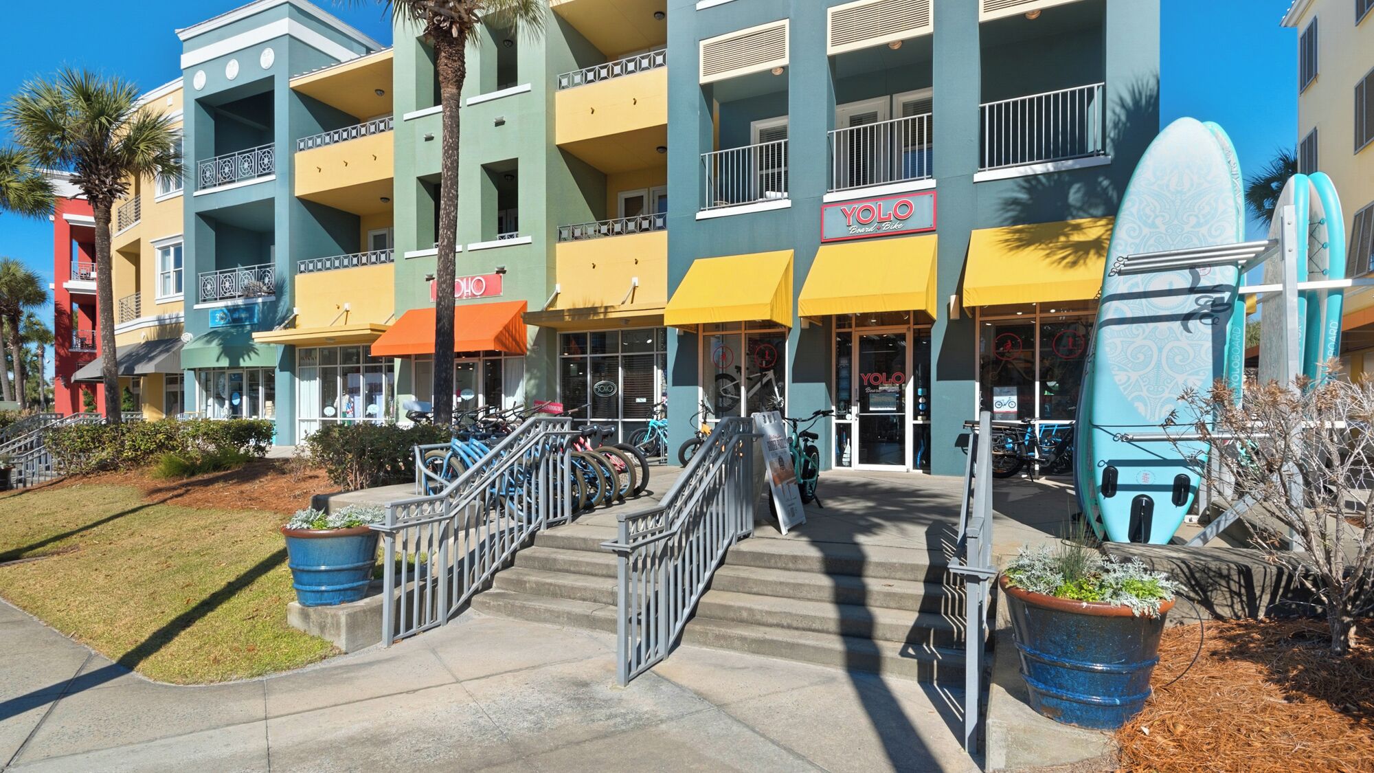 A multi-story building with a storefront named "YOLO Bike Shop."