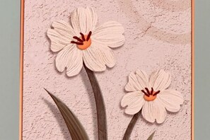 Two artificial flowers on a textured wall. - Qiaoyu Inn (Zhoushan)