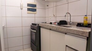 A compact kitchen with a sink, stove, and oven. - Beach Class Excelsior  (Recife)