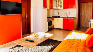 A compact living space with a kitchen, a dining area, and a sofa. - Beachfront Apartment With Stunning Sea Views (Durrës)