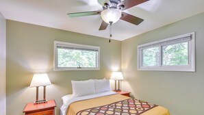 A bedroom with a bed, two bedside tables with lamps, a ceiling fan, and two windows with blinds. - 5 Mi to Warren Dunes - Secluded Sawyer Home! (Sawyer)
