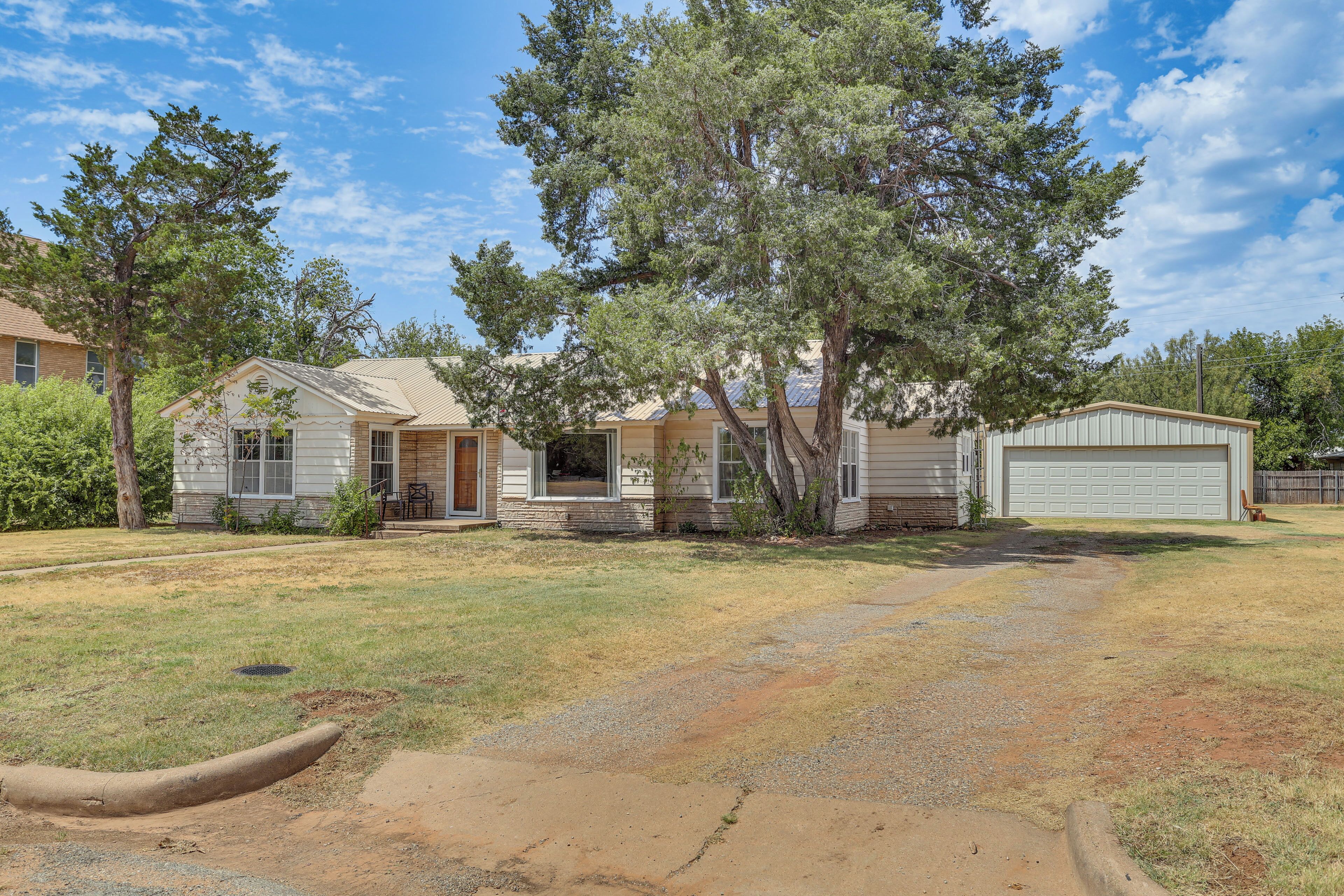 A residential area with houses, a driveway, and a garage.