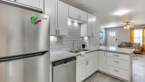 A modern kitchen with stainless steel appliances, white cabinetry, and a dishwasher. - 3 Mi to Brunswick Community College: Cozy Duplex! (Bolivia)