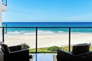 A balcony with a view of a beach and ocean. - Absolute Beachfront 3BR Apartment | Pool, Spa, Tennis & Ocean Views (Surfers Paradise)