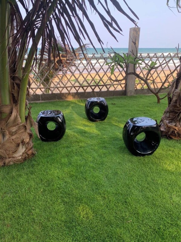 A grassy area with three black spherical objects.