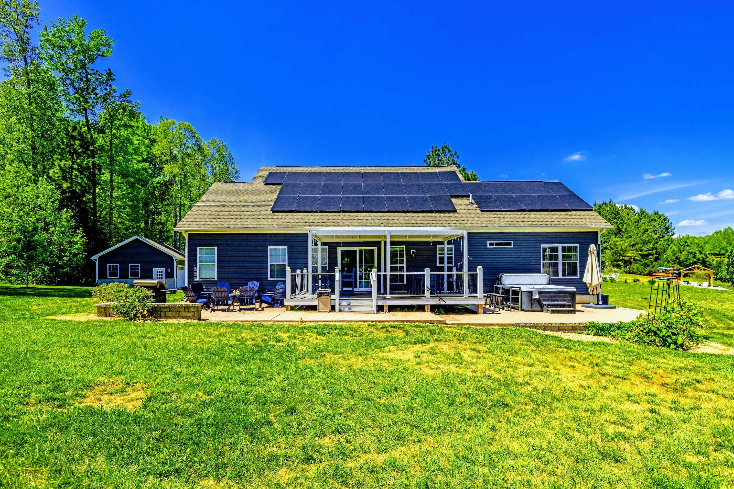 Backyard - Generous lawn, covered back porch, fire pit lounge, and hot tub all set for a long weekend at the lake.