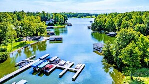 A marina with docked boats, a pier, and surrounding greenery. - Lakefront Lake Anna, Hot Tub, Pool, Beach (Mineral)