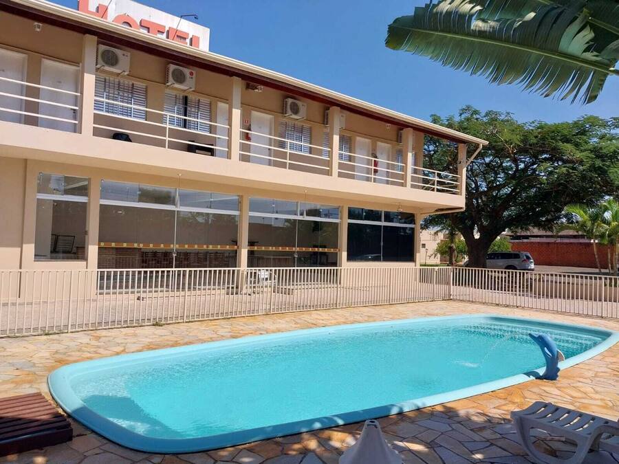 A two-story building with a swimming pool in front.