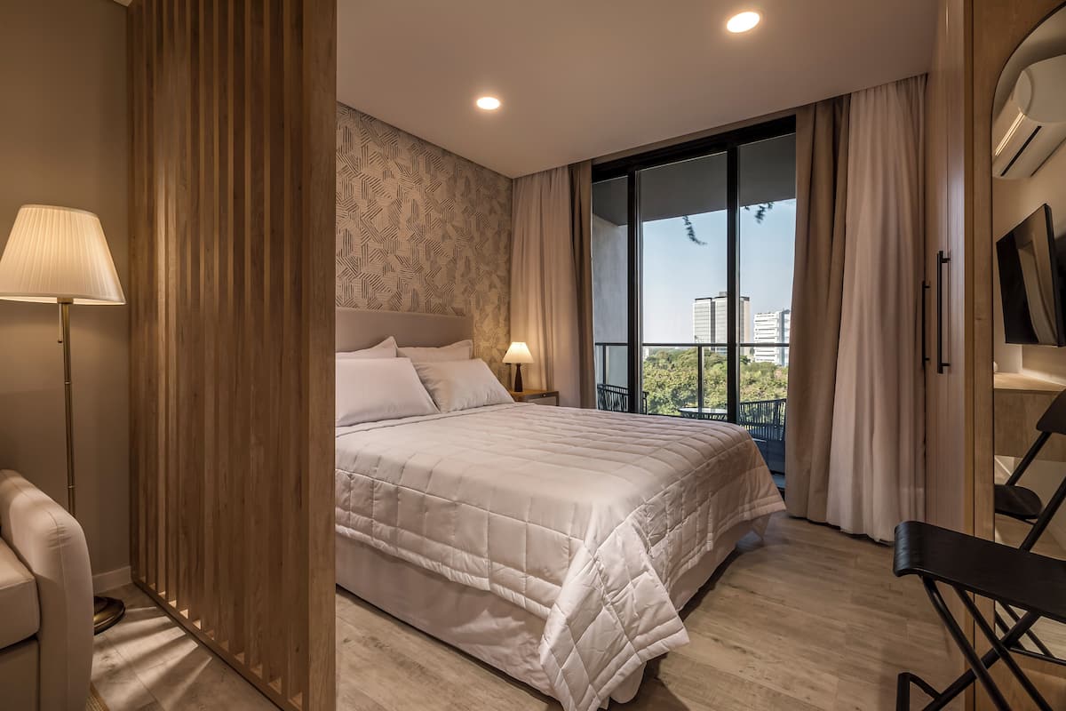 Deluxe Studio, Balcony, City View | 1 bedroom, laptop workspace, blackout drapes, soundproofing