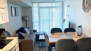 A modern kitchen with a built-in oven and a dining area with a table and chairs. - GLOBALSTAY. Charming Lake View 1bd+den in Downtown (Toronto/Canada)