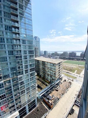 A high-rise building with a glass facade and a view of a construction site below. - GLOBALSTAY. Charming Lake View 1bd+den in Downtown (Toronto/Canada)