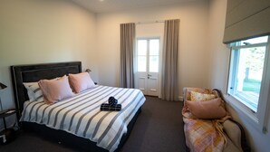 A bedroom with a bed, a chair, a window, and a door. - Ravenscroft Cottage - Three Bedroom House, Sleeps 6 (Eccleston)