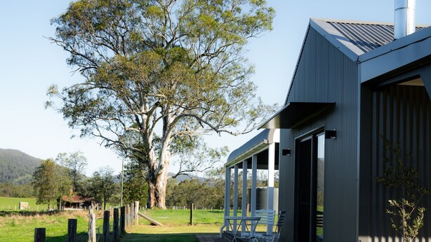 A modern house with a large tree in the yard, a covered porch, and a chimney. - Ravenscroft Cottage - Three Bedroom House, Sleeps 6 (Eccleston)