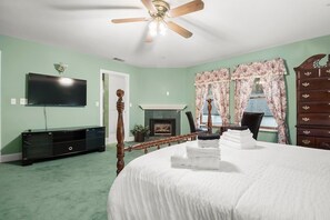 A bedroom with a bed, a television, a fireplace, and a dresser. - Luxury Mountain Retreat: Skiing, SPA, Arcade & Bar (Wrightwood)
