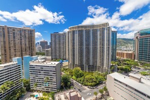 A high-rise urban area with multiple buildings, including a prominent hotel with a modern design and a rooftop pool area.